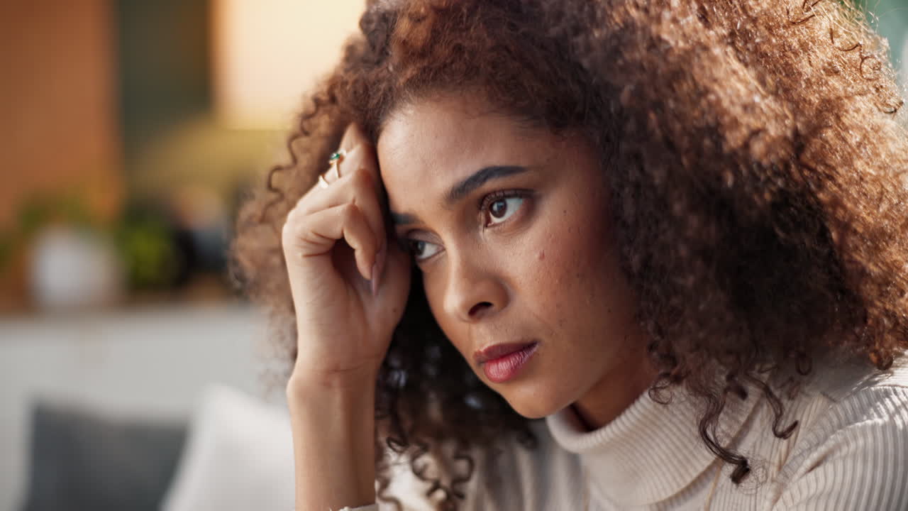 A sad woman with curly hair