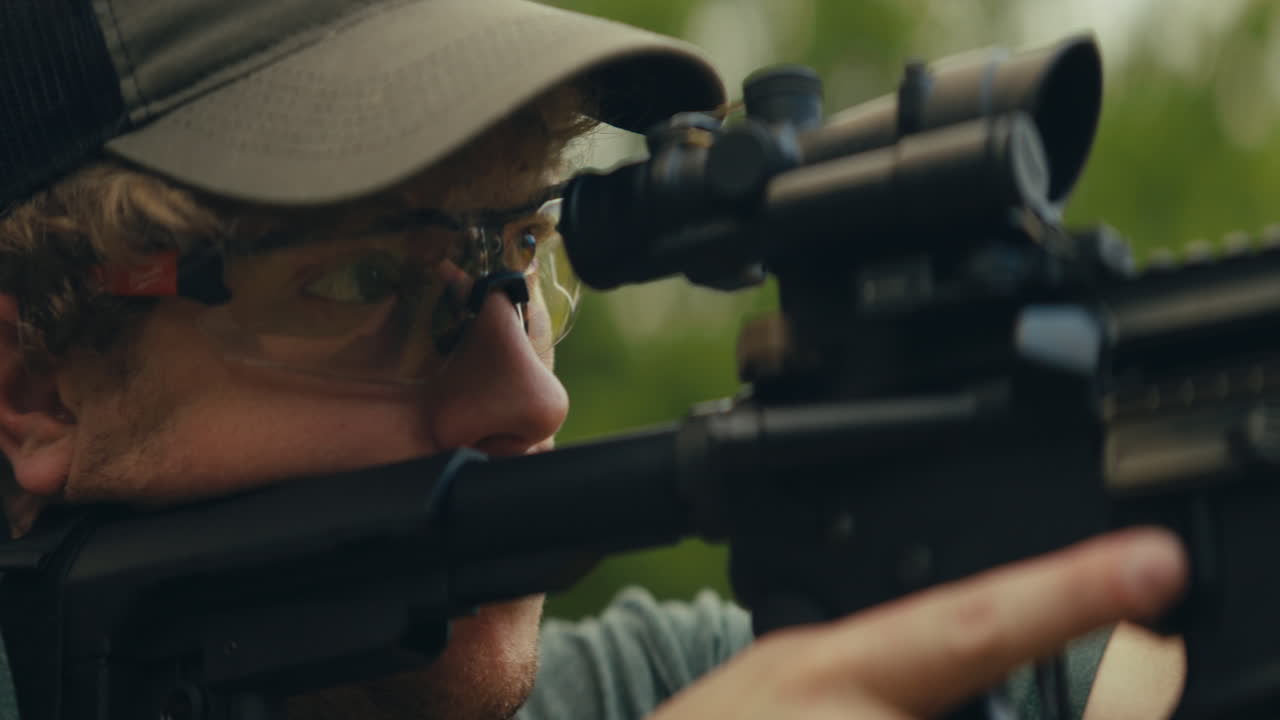 Man wearing safety glasses with a rifle