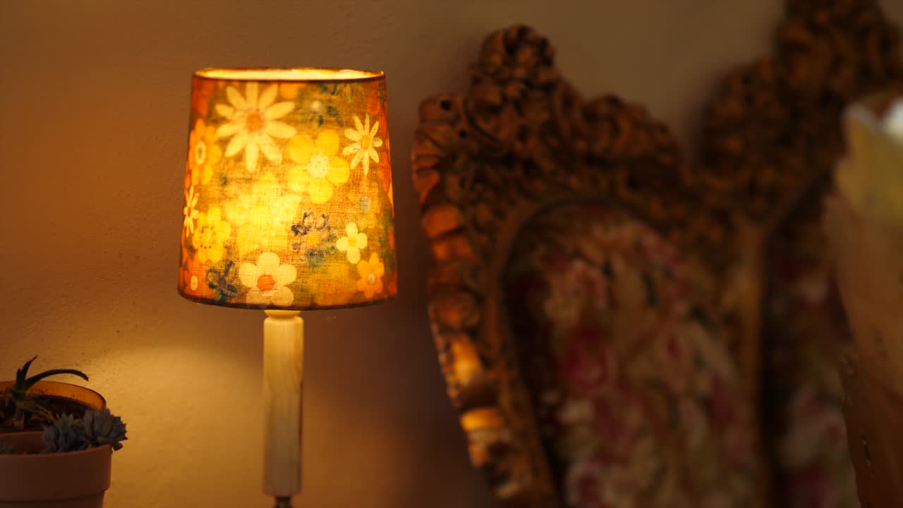 Warm Glow of a Retro Floral Table Lamp in a Cozy Room