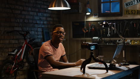 man vlogging in a home garage studio