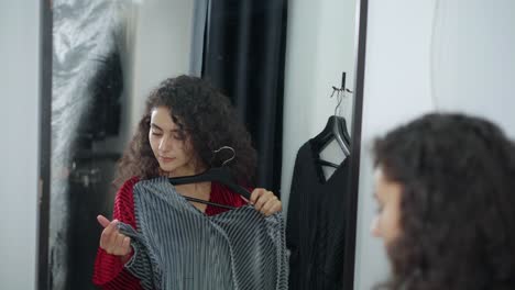 woman trying on clothes in dressing room