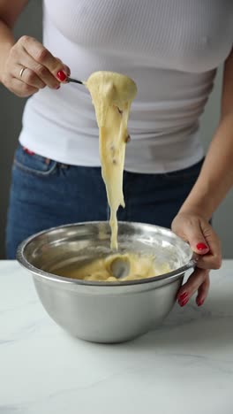 woman mixing dough in a bowl