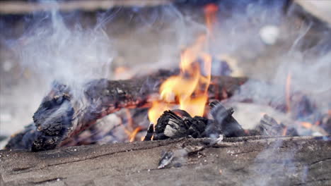 bonfire consuming the wood in slow motion with flames shooting in the air