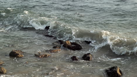 Reminiscing-memories-with-waves-hitting-rock-stones-on-the-beach-of-Big-Rock-in-Malibu-California