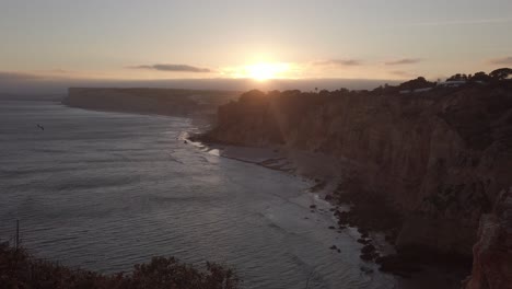 Last-rays-of-sunlight-cast-over-golden-hour-Lagos-shoreline-cliffs,-Portugal