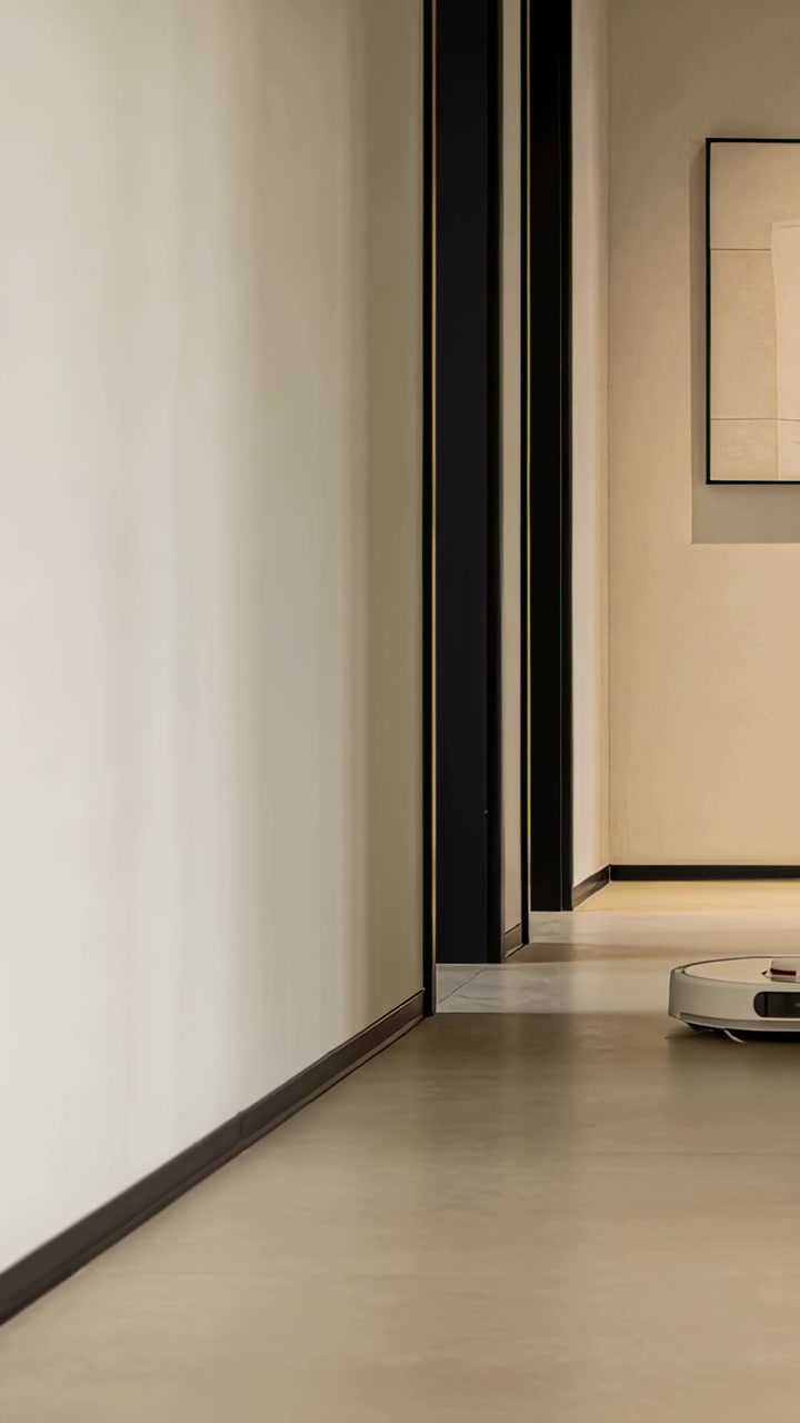 Vertical video: Crossing door starting robotic vacuum moving down home hall cleaning, copy space