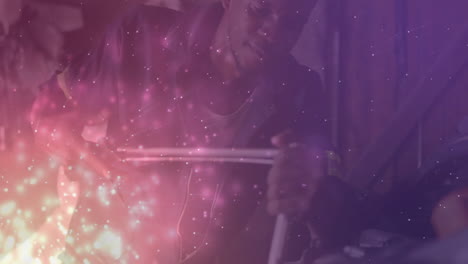 drummer using drumsticks under pink purple sparkles in music studio with wooden acoustic panels
