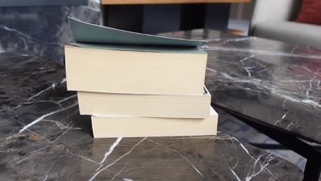 books stacked on a marble coffee table