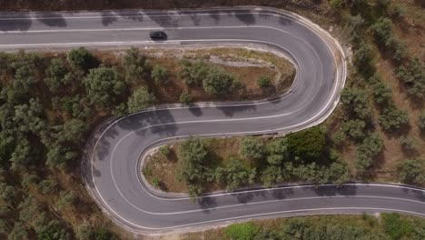 Topdown-view-of-two-consecutive-haipin-turns,with-some-cars-coming-and-going