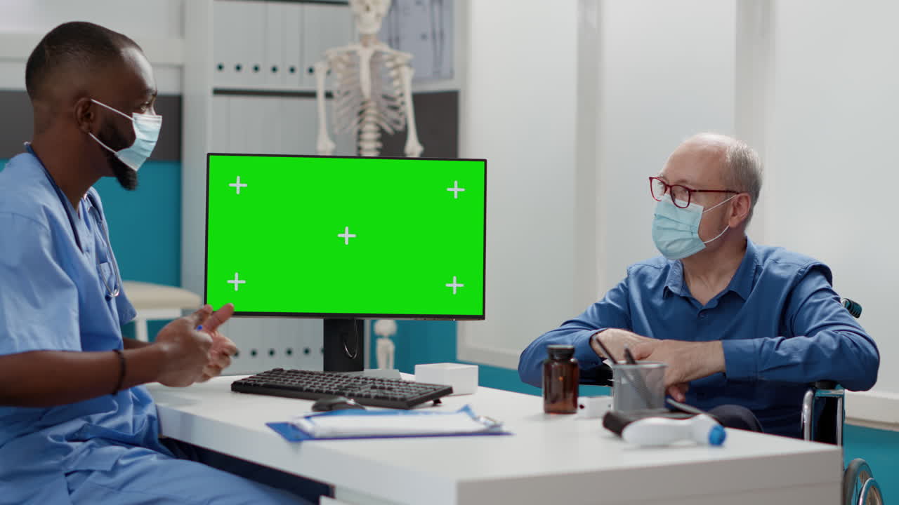 Doctor consulting with patient using green screen computer