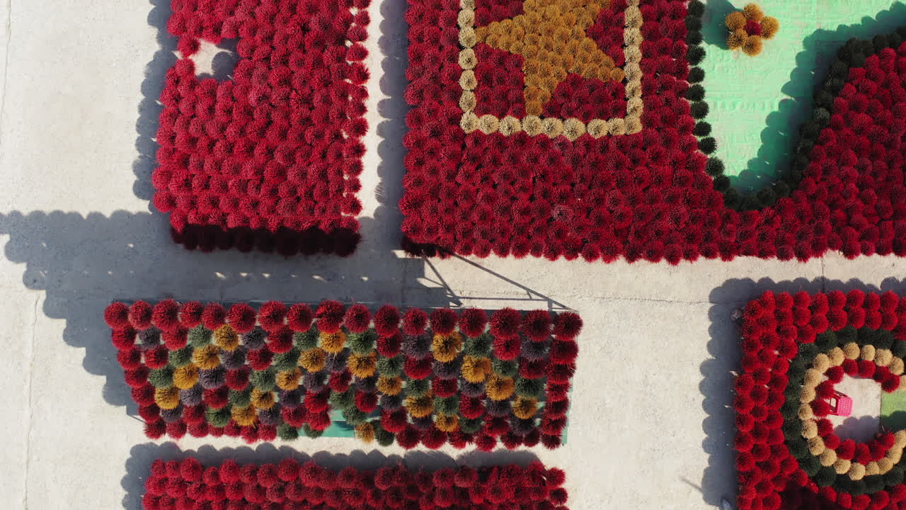 Colorful incense mats being carefully arranged under the sun at Quảng Phú Cầu village