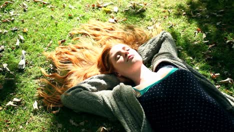 young redhead relaxing on lawn