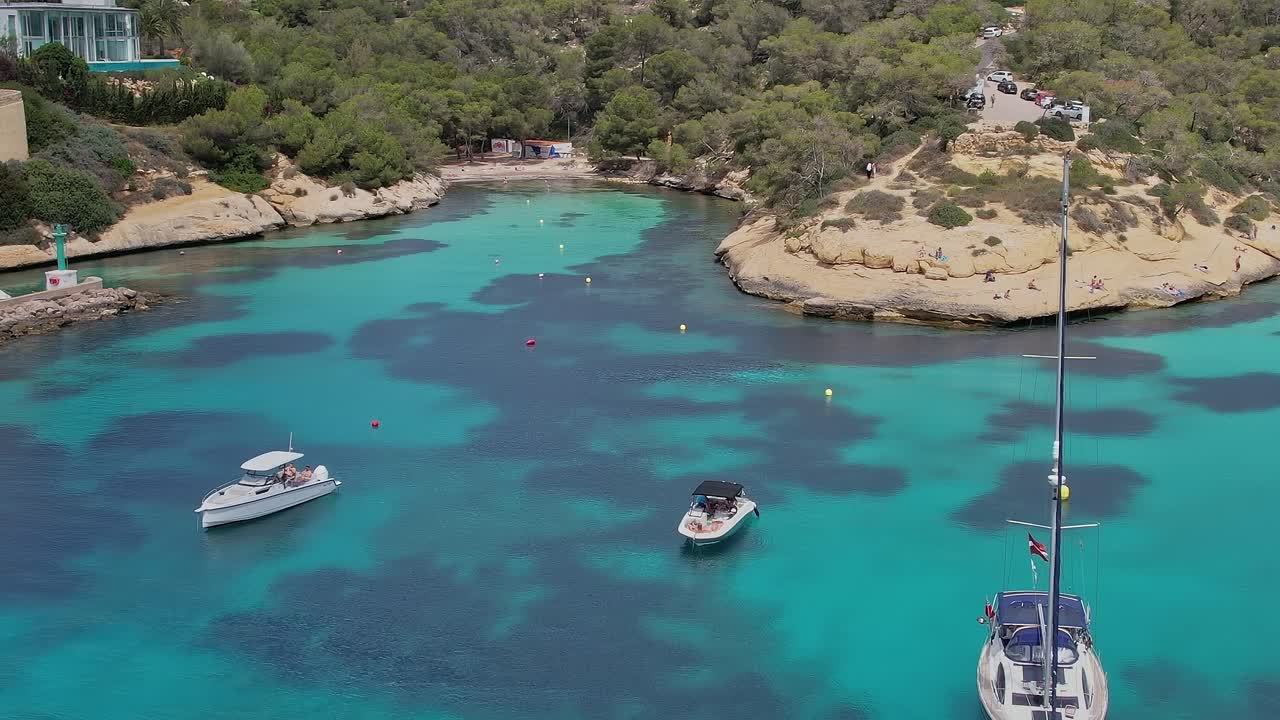 Exploring the coastal waters of Mallorca with boats anchored in clear blue