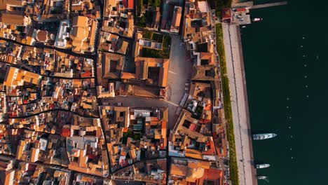 ortigia, syracuse, sicily, italy. top-down aerial of labyrinth alleys, old city center, cathedral and harbor.