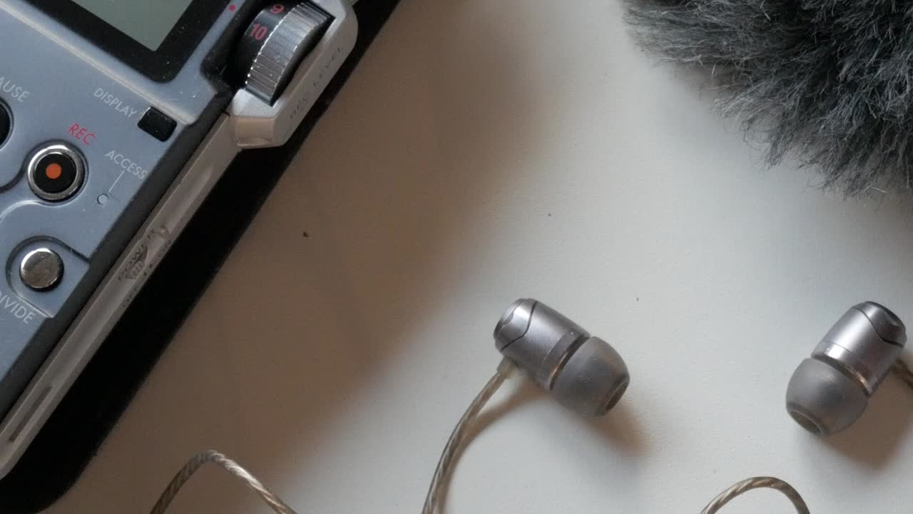 Sound recorder kit, showing earphones connected to a device for capturing audio