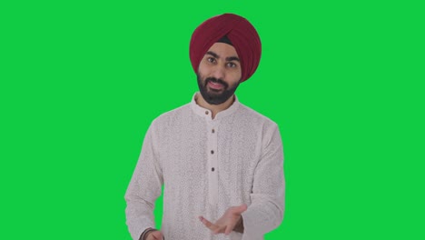 happy sikh indian man talking to the camera green screen