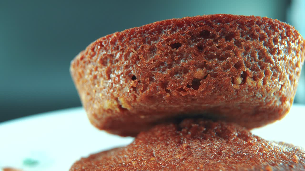 A macro close up shot of tasty cupcakes, on a 360 rotating stand, cinematic studio lighting, slow motion, smooth movement, 4K video