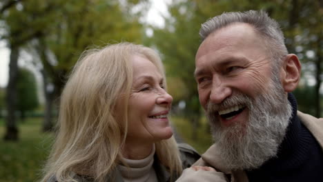 portrait of senior family having fun outdoors. smiling elderly couple walking