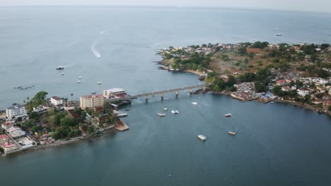 aerial hyperlapse of the aberdeen bridge in freetown, sierra leone with boats driving around