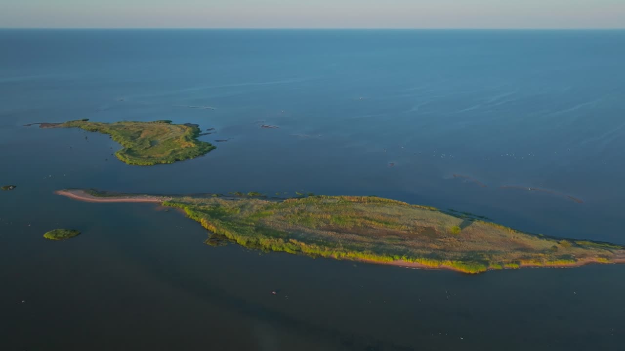 Drone shot of green islands islets in summer, moving over, revealing green coastline