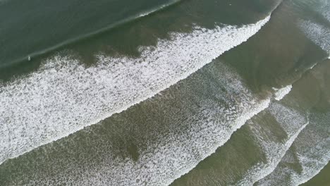 aerial view. aerial drone footage of ocean waves breaking on shore. flying the ocean