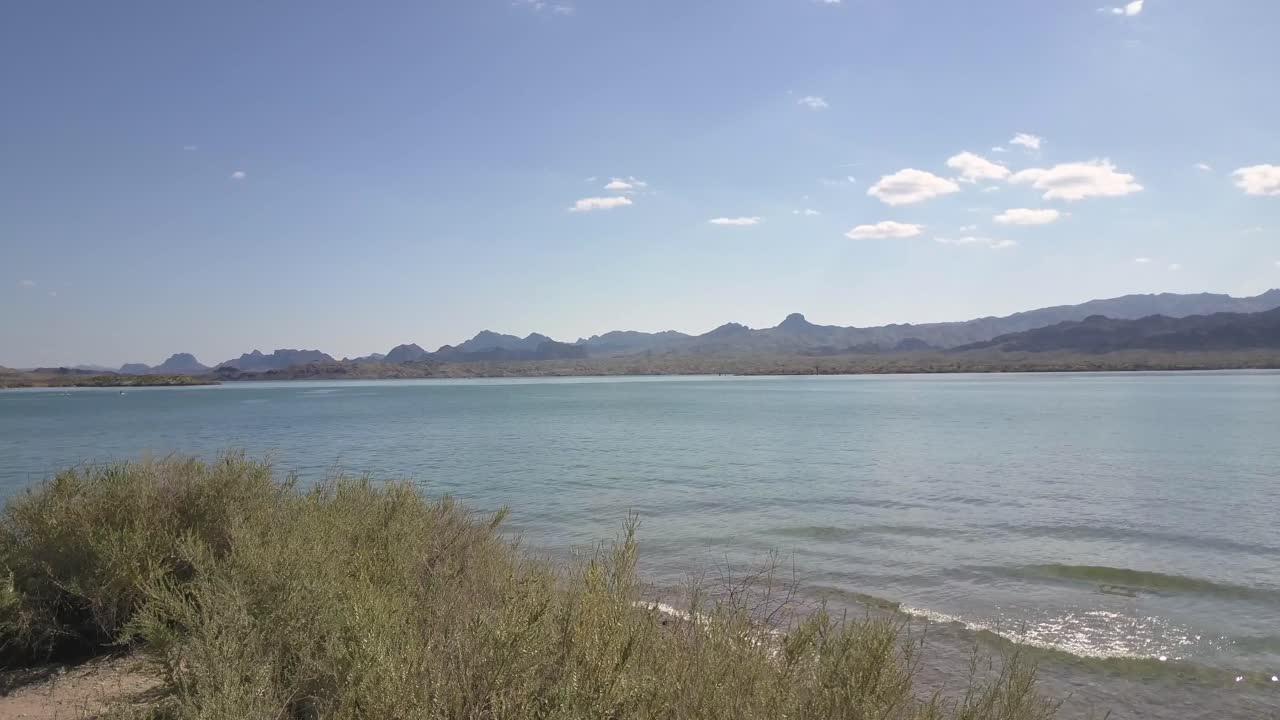 Lighthouse On Lake With Mountains 4k