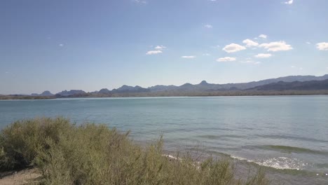 lighthouse on lake with mountains 4k