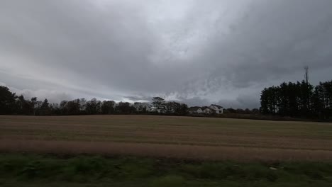sitting in a car to drive past a field