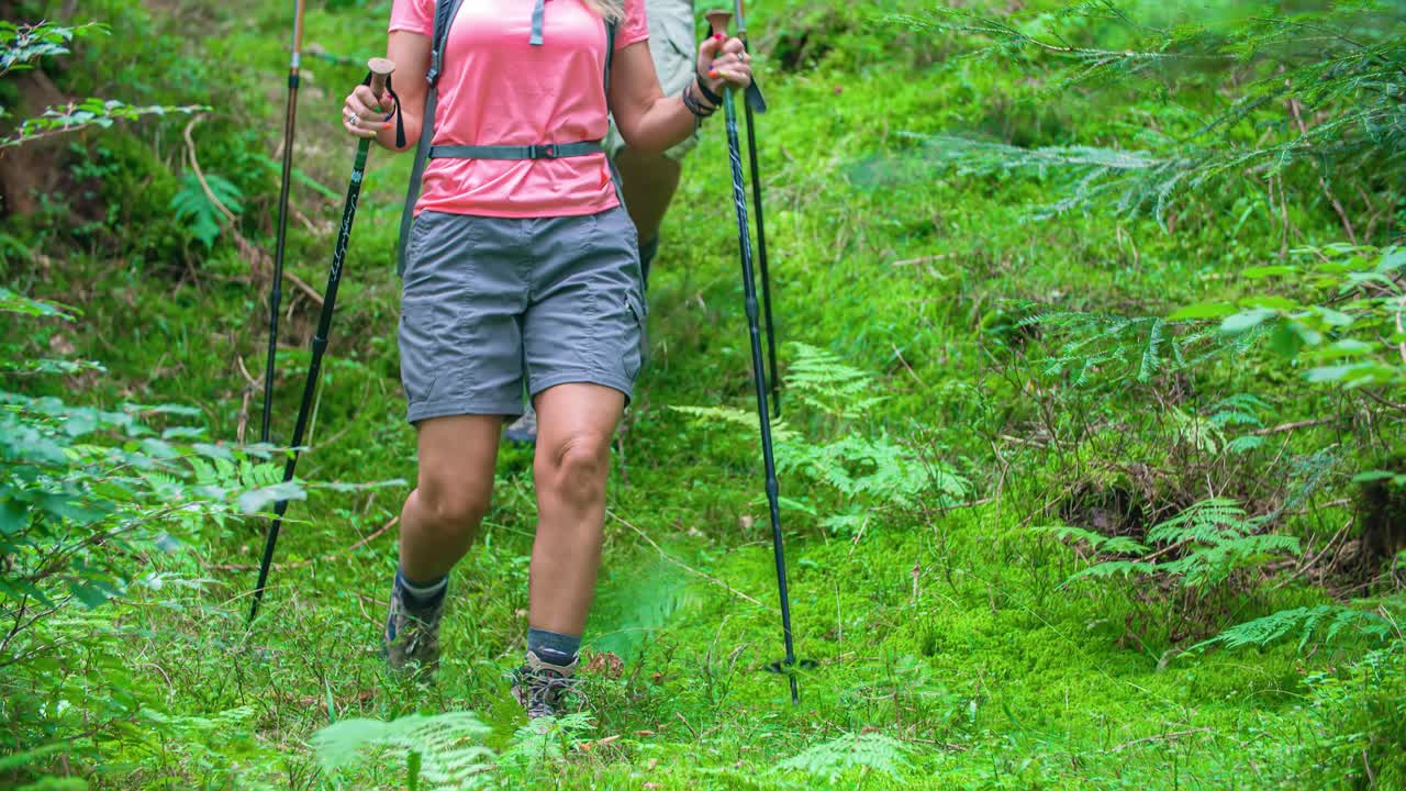 low angle slow motion of legs of a couple hiking together, Topla Valley