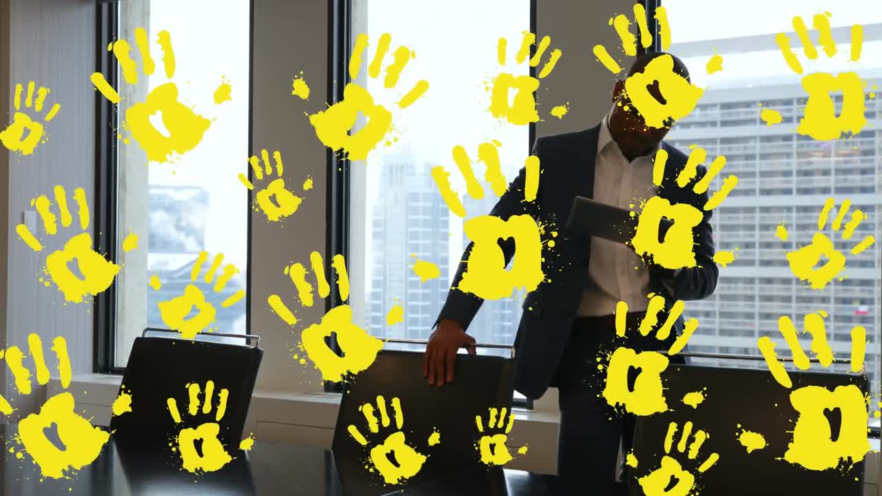 Animation von gelben Händen über einem kaukasischen Geschäftsmann im Büro.