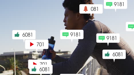 animation of changing numbers, icons in notification bars, african american athlete drinking water