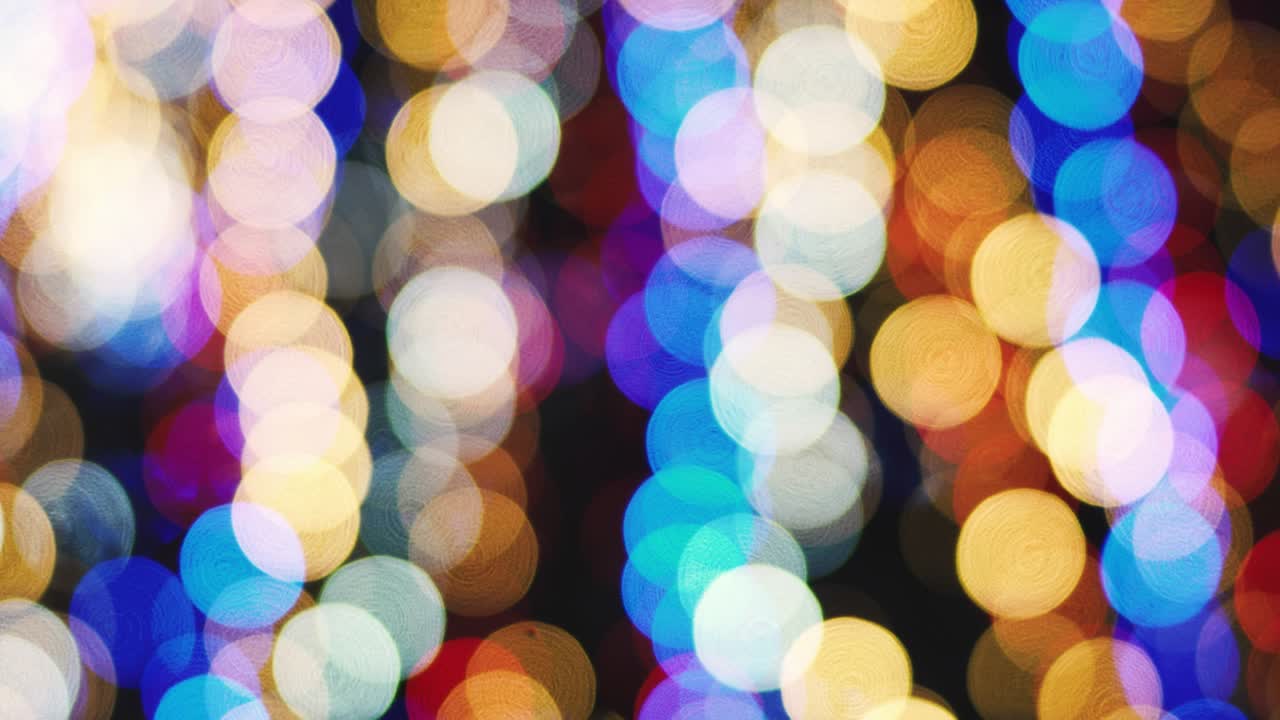 Christmas lights bokeh background adorn the floor of a large modern shopping center. Blurred bright Christmas lighting in the mall. Glitter