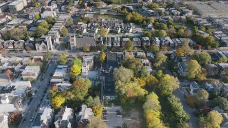 aerial flyover of neighborhoods and streets in west philadelphia revealing a baseball field