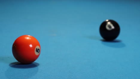 playing a game of pool billiards hitting the red ball with the black ball