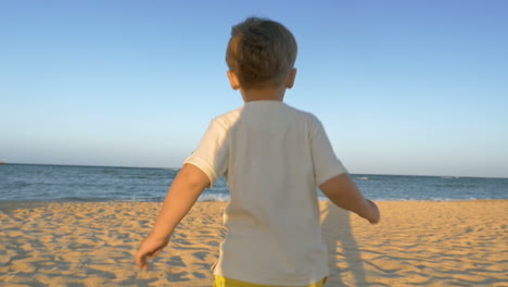 boy running to the sea