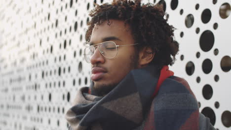 portrait of a young man wearing glasses and scarf