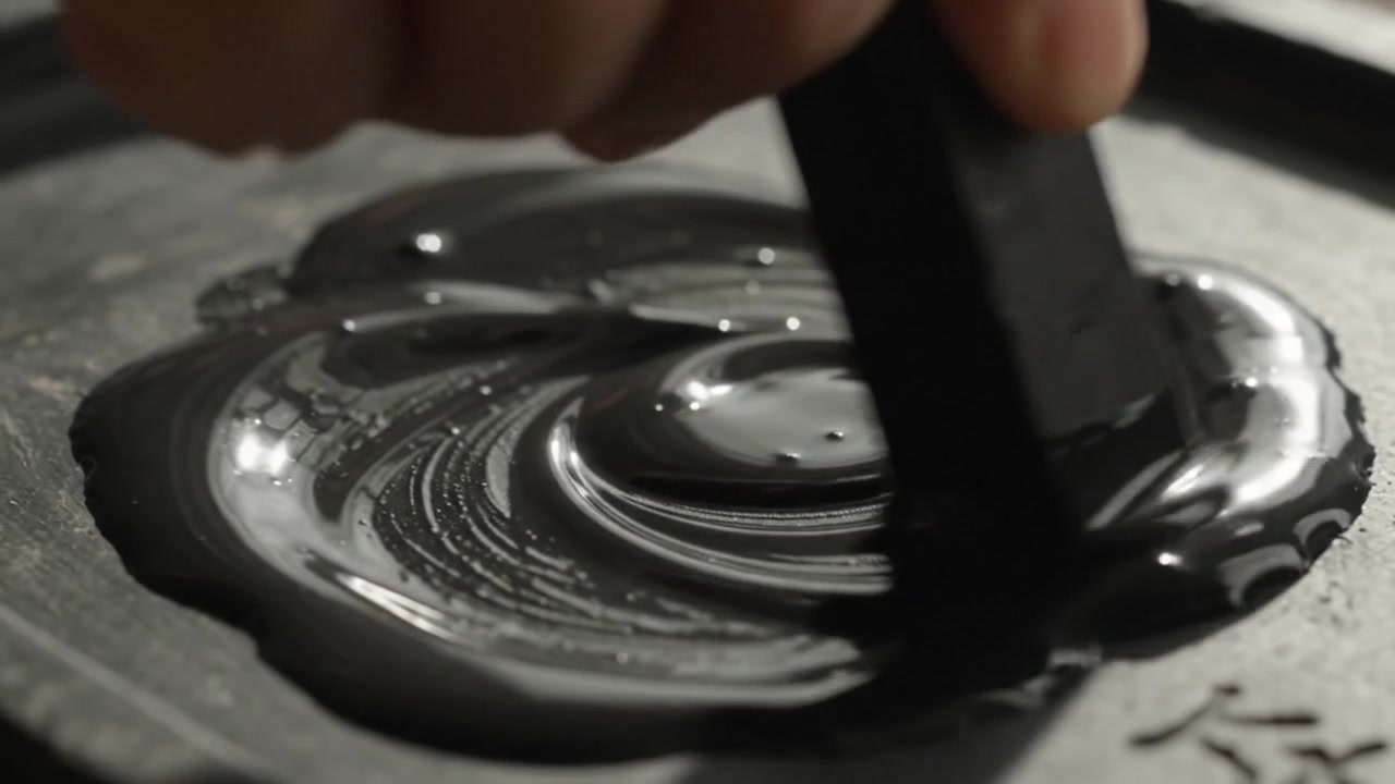 Artist Grinding Ink Stick on Stone for Traditional Calligraphy