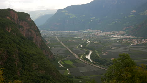 Rural-landscape-of-mountains-in-Italy,-Brenner-motorway,-Etsch-river-and-Bozen-City-in-background