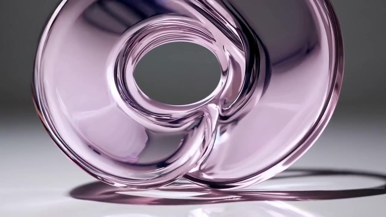 Abstract Transparent Glass Torus Rotating on Reflective Surface