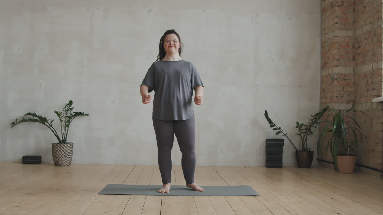 Young Woman With Down Syndrome Standing In Yoga Pose