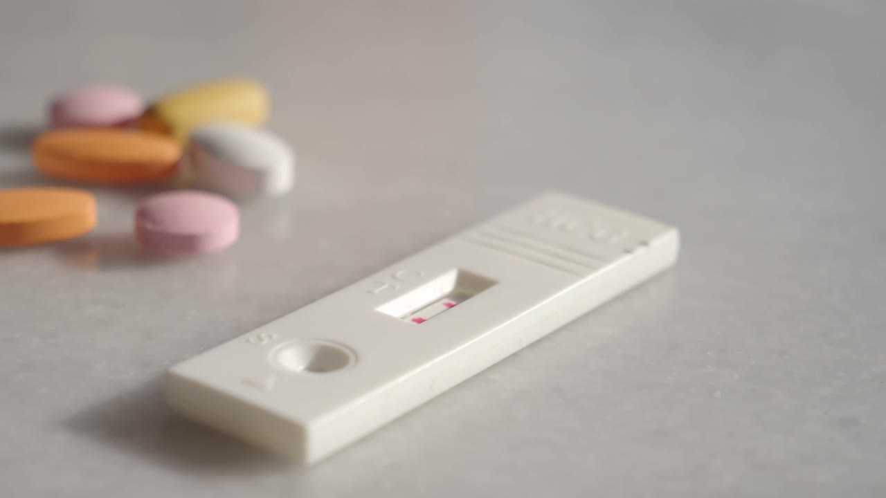 Pregnancy test and pills on a table