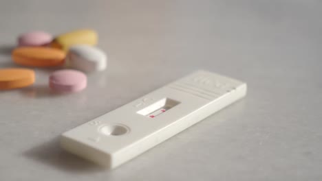 pregnancy test and pills on a table