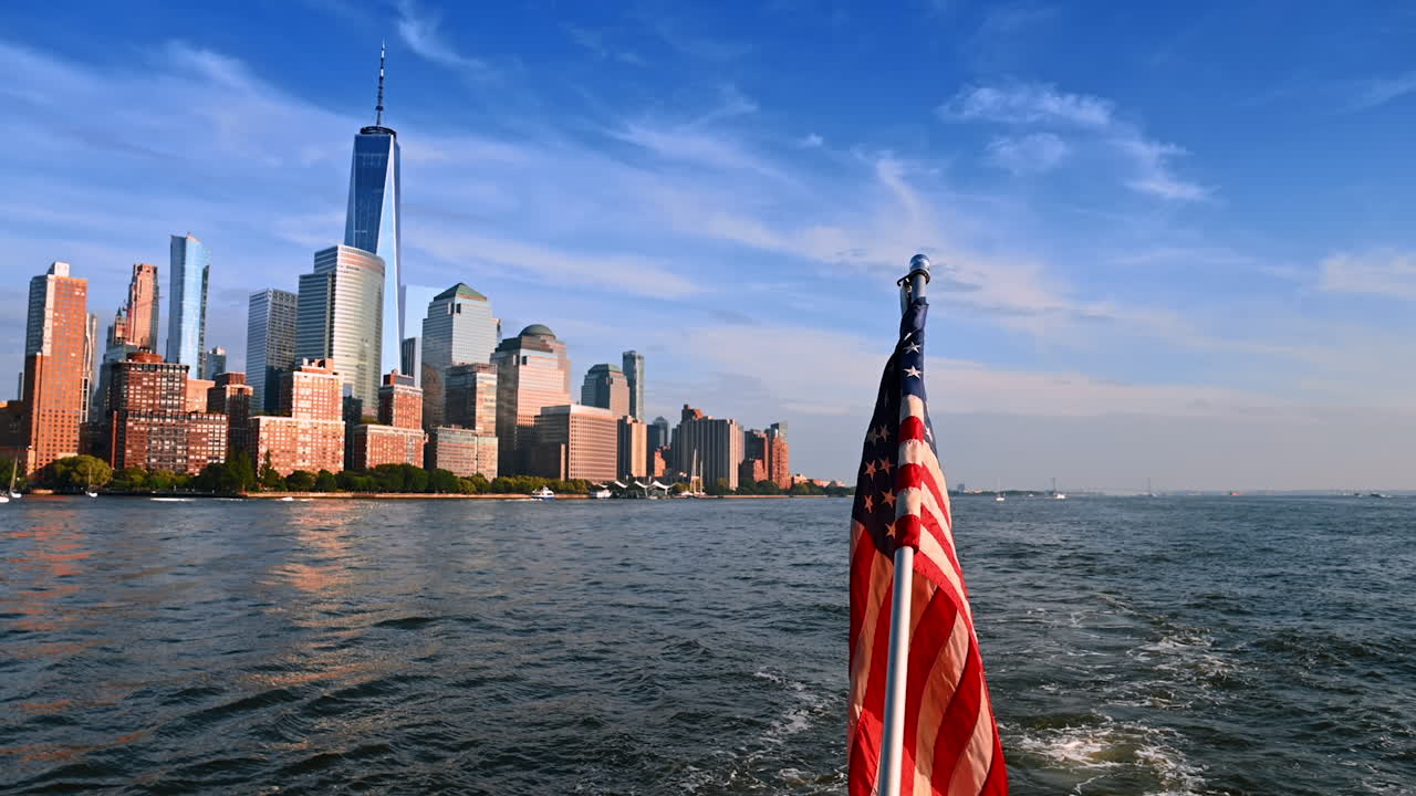 Travel by the East River on the boat with American flag. View on the Manhattan skyline from the riverscape