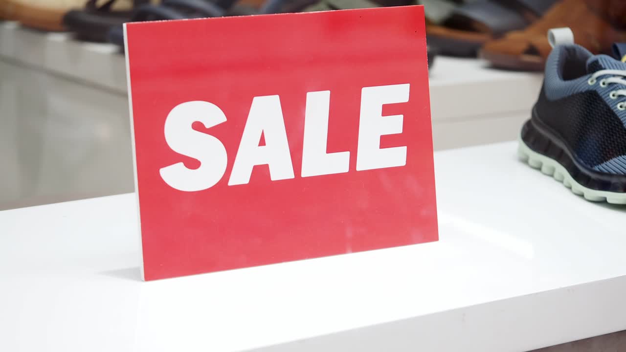 Red 'SALE' Sign in a Retail Store Display