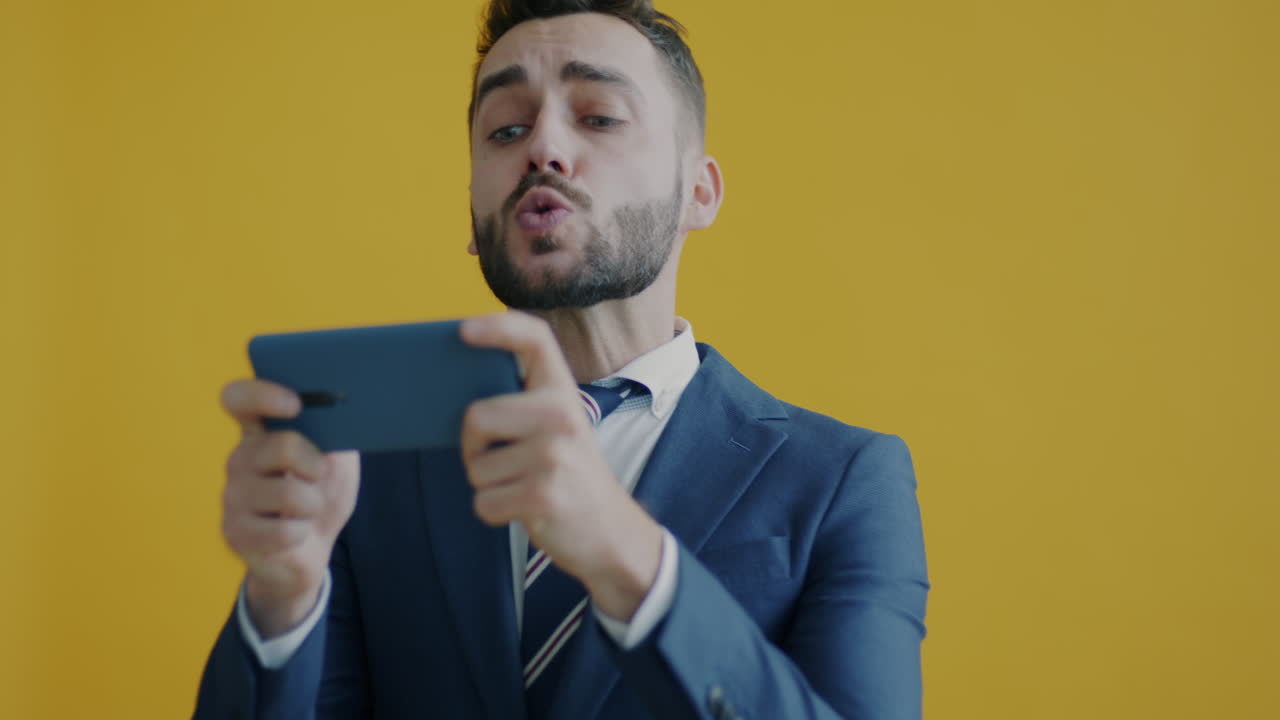 Businessman playing a game on his smartphone