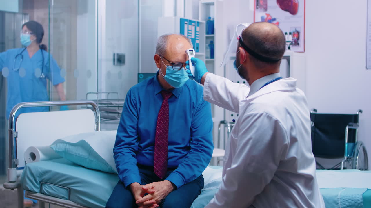 Doctor using infrared thermometer