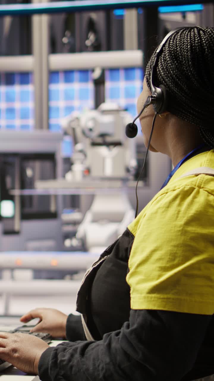 Vertical video Technician remotely supervising smart factory production lines