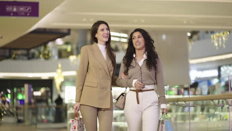 two women enjoying a shopping trip in a modern mall