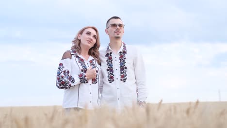 extremely beautiful ukrainian family in embroidered dresses standing in a wheat field against extremely beautiful ukrainian family in embroidered dresses standing in a wheat field against the background of the sky ukrainian family dad mom and daughter photo session in the field