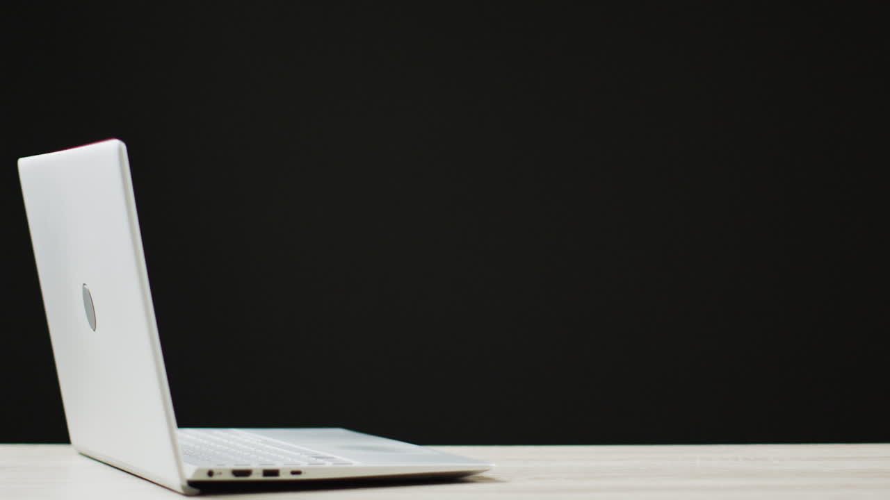 Video of laptop with copy space on black background